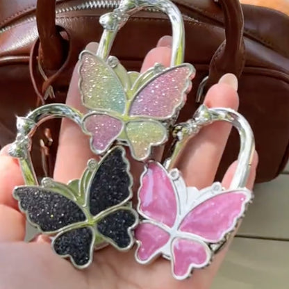 🦋Foldable Purse Hook for Table - Portable Bag Holder,Folding Handbag Hanger Various Heavy Items Desk Hook