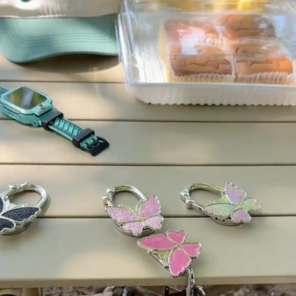 🦋Foldable Purse Hook for Table - Portable Bag Holder,Folding Handbag Hanger Various Heavy Items Desk Hook