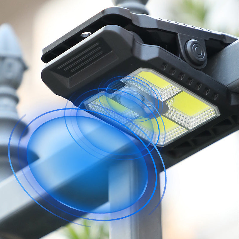 Outdoor solar-powered light with clip and motion sensor